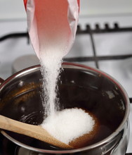 Pouring Sugar Into Treacle Syrup