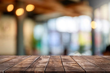 Empty wood table top and blur glass window interior restaurant banner mock up abstract background - can used for display or montage your products.