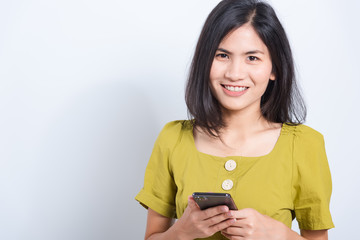 Wall Mural - young woman standing smile holding using mobile smart phone