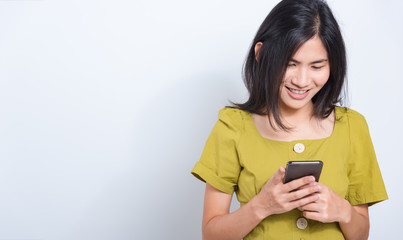 Wall Mural - young woman standing smile holding using mobile smart phone