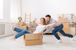 © Prostock-studio - Young couple having fun while moving to a new apartment