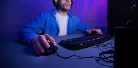 Unrecognizable Man Playing Computer Games Overnight Sitting Indoor, Cropped, Panorama