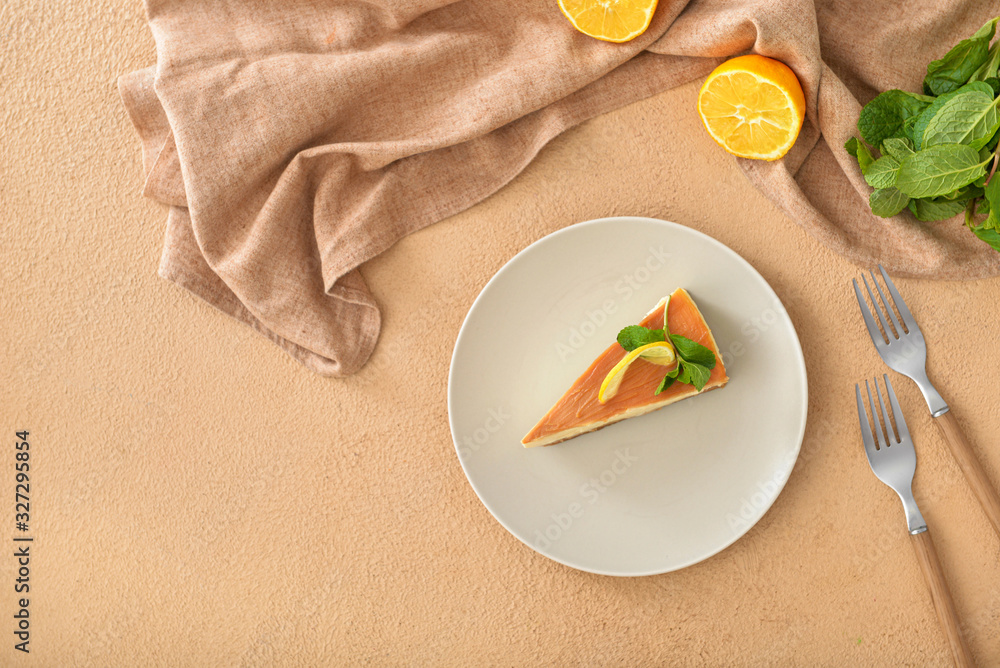 Slice of sweet caramel cheesecake on color background