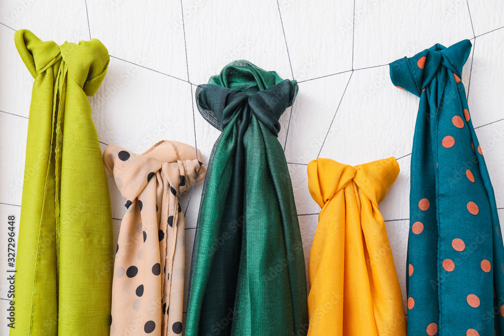 Different beautiful scarves on white background