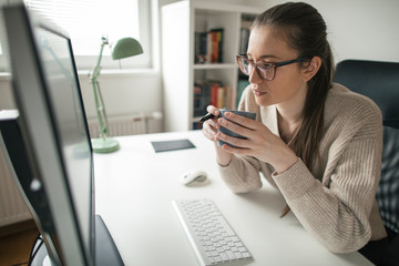 businesswoman working long hours from her home office