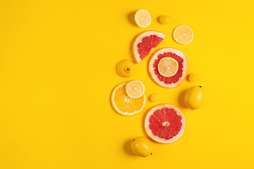 Composition of citrus fruit, orange and lemon on yellow background