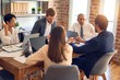 © Krakenimages.com - Group of business workers working together. Sitting on desk using laptop and talking at the office