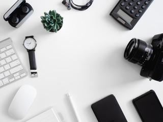 Wall Mural - top view of photographer work station, work space concept with digital camera, memory card, keyboard and smartphone on white table background