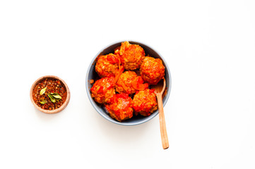 Wall Mural - Meatballs in blue bowl on white isolated background. Close-up