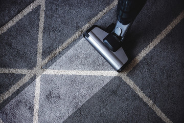 Close up of steam cleaner cleaning very dirty carpet.