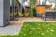 Yellow armchairs and grey sofas in the garden of single family home