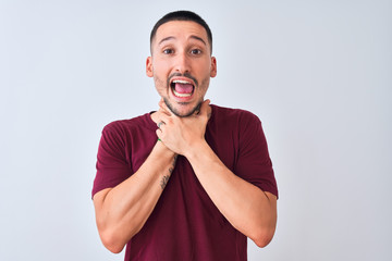 Wall Mural - Young handsome man standing over isolated background shouting and suffocate because painful strangle. Health problem. Asphyxiate and suicide concept.