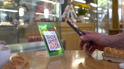 QR code cashless payment. Scan to pay system. Business or technology concept: using smartphone for scanning QR code for paying in the cafeteria