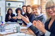© Krakenimages.com - Group of business workers smiling happy and confident. Working together with smile on face looking at the camera applauding at the office