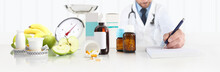 Dietitian Nutritionist Doctor Prescribes Prescription Sitting At The Desk Office With Apple, Yogurt, Medical Drugs, Tape Meter And Scale, Healthy And Balanced Diet Concept, Web Banner Copy Space 