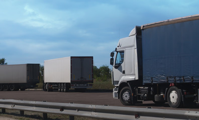 Poster - trucks in the parking lot outside the city