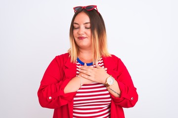 Sticker - Young beautiful woman wearing striped t-shirt and jacket over isolated white background smiling with hands on chest with closed eyes and grateful gesture on face. Health concept.