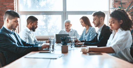 Business People Working Sitting Together At One Table In Office