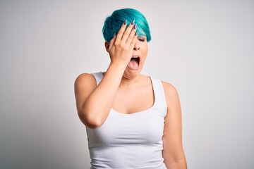 Sticker - Young beautiful woman with blue fashion hair wearing casual t-shirt over white background Yawning tired covering half face, eye and mouth with hand. Face hurts in pain.