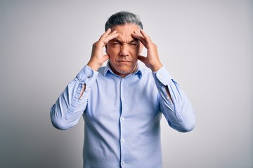 Poster - Middle age handsome grey-haired business man wearing elegant shirt over white background with hand on head for pain in head because stress. Suffering migraine.