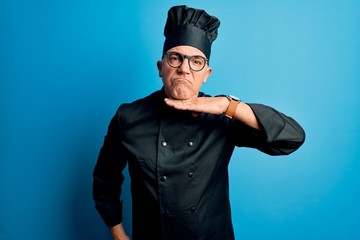 Sticker - Middle age handsome grey-haired chef man wearing cooker uniform and hat cutting throat with hand as knife, threaten aggression with furious violence