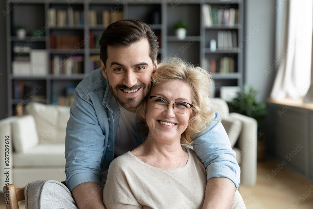 Portrait of grateful adult son hugging senior mother Stock Photo | Adobe Stock
