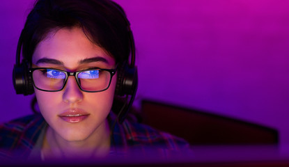 Wall Mural - Concentrated Girl Playing Game Sitting At PC Indoor At Night