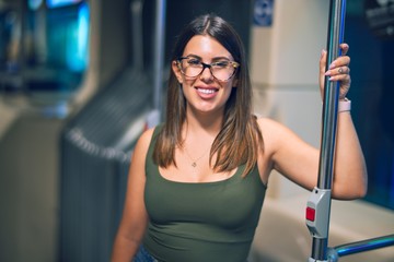 Young beautiful woman smiling happy and confident. Standing with smile on face travelling by bus