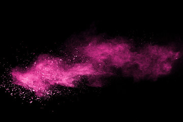 Wall Mural - pink powder explosion on black background. colored cloud. colorful dust explode. paint holi.