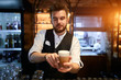 © the faces - young talented bearded attractive barista has made tasty latte, close up photo. service concept, job, profession, occupation. man serves customers in a coffee shop