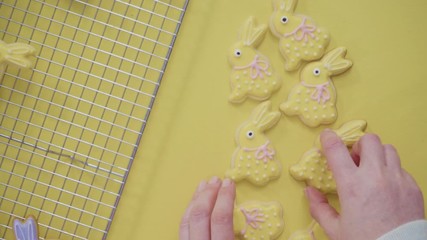 Sticker - Time lapse. Flat lay. Easter sugar cookies decorated with royal icing of different colors.