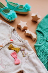 Wall Mural - Close up of baby girl knitted clothes and shoes