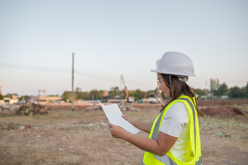 Asian engineer working at site of a large building project,Thailand people,Work overtime at construction site