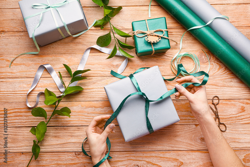 Woman packing gifts at table