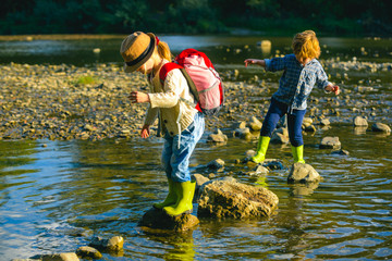 Wall Mural - Children traveling and exploring little couple holding hands, travel concept.