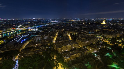 Wall Mural - Aerial Night timelapse view of Paris City and Seine river shot on the top of Eiffel Tower