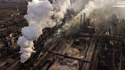 Steel ecology metallurgical iron plant smokes from pollution of industry pipes. View from the drone.