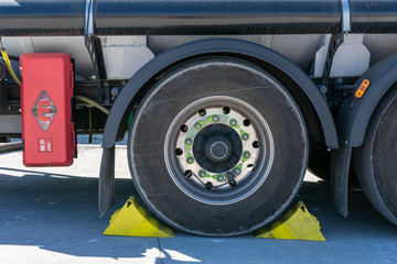 Wall Mural - Tanker truck wheel with chocks placed for safety