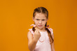 © producer - angry little child girl in dress raising fist frustrated and furious. Human emotions and facial expression
