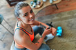 © Valerii Apetroaiei - Woman checking her workout time at home. Sport, fitness, lifestyle, technology and people concept - woman setting heart-rate watch.