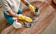 © Valerii Apetroaiei - Beautiful young woman makes cleaning the house. Girl rubs dust. Woman in protective gloves is smiling and wiping dust using a spray and a duster while cleaning her house.