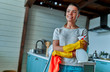 © Valerii Apetroaiei - Cleaning concept. An attractive woman in casual clothes and protective gloves with a rag and spray in her hands is about to do general cleaning in the kitchen.