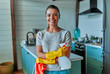 © Valerii Apetroaiei - Cleaning concept. An attractive woman in casual clothes and protective gloves with a rag and spray in her hands is about to do general cleaning in the kitchen.
