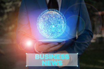 Writing note showing Business News. Business concept for information reported in a newspaper or news magazine Elements of this image furnished by NASA