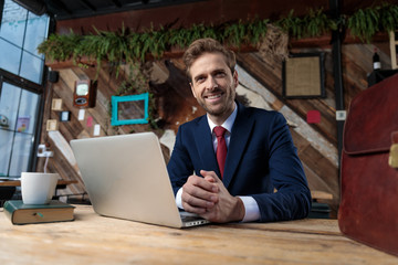 Wall Mural - smiling young businessman touching hands in coffeeshop