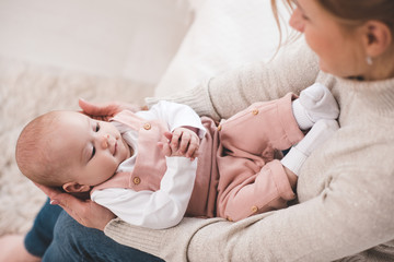 Mother holding baby on hands closeup. Motherhood. Maternity.