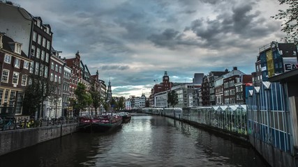 Wall Mural - Famous attractions and canals of Amsterdam city. General view of the cityscape and traditional Netherlands architecture. 4K Time Lapse 2 in 1.