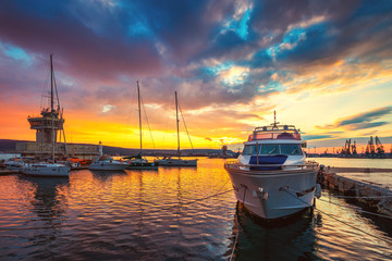 Wall Mural - Yacht port and beautiful sunset over Varna, Bulgaria. Sailboat harbor, many beautiful moored sail yachts in the sea