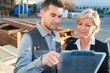 © auremar - male employee signing a contract with female manager with clipboard