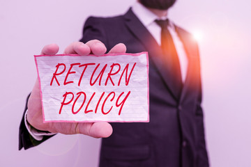 Writing note showing Return Policy. Business concept for return or exchange defective merchandise that they buy before Male human wear formal work suit with office look hold book